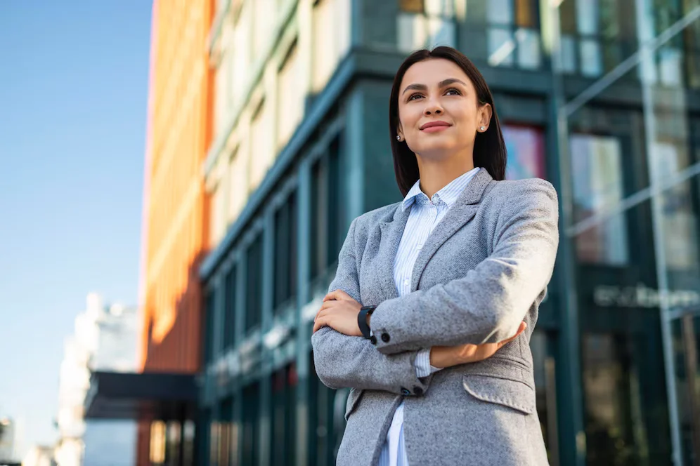 low-angle-businesswoman-posing-with-arms-crossed-outdoors_23-2148767034 low-angle-businesswoman-posing-with-arms-crossed-outdoors_23-2148767034